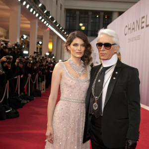 Laetitia Casta and Karl Lagerfeld at the CHANEL fashion show. Lavish red carpet, flashing cameras