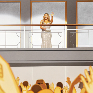 Hilary Duff, glamorous look, waving at crowded award show. The audience is loud and enthusiastic.