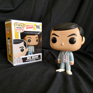Funko Pop vinyl figurine of Mr Bean in pajamas displayed on a black backdrop, packaging box visible next to it.
