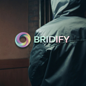 Digital artwork showcasing Bridify's new logo. The logo features a sleek, abstract swirl design alongside the brand name in a modern font. Colors are a blend of soft and vibrant hues, set against a light, neutral gray backdrop.