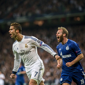 Cristiano Ronaldo and Jan Kirchhoff in a heated soccer match. Cristiano in Real Madrid jersey, Jan in Schalke 04 uniform. Crowded stadium background.