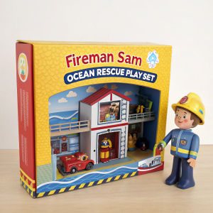 Colorful packaging of Fireman Sam Ocean Rescue Playset. Toy features cartoon character Fireman Sam, detailed fire station layout, and rescue-themed accessories. Original box design with window display.