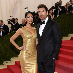 Shasi Wells and Dylan McDermott at the Met Gala. Shasi in a form-fitting gold dress, Dylan in a classic black tuxedo.