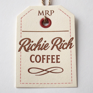 Vintage Richie Rich paper tag. White background with brown cursive font. Coffee terminology highlighted. Part of a collectible MRP item.