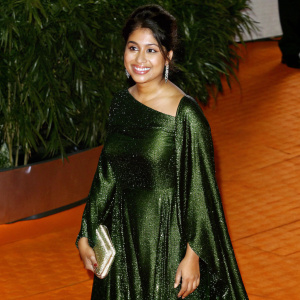 Shilpa Yarlagadda at the Venice Film Festival. Wearing a green sequined dress, posing with a smile, red carpet event