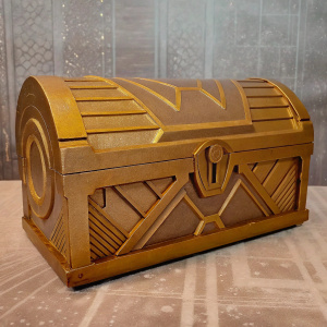 Digital artwork showcasing the Typhon Chest from Borderlands 3. Futuristic design with metallic finish and detailed patterns. Gray backdrop with digital texture.