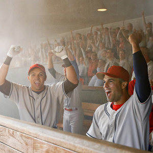 Manny Machado and Jace Peterson, baseball players, celebrating a home run in the dugout. Cheerful crowd in the background