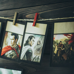 A collage of vibrant stickers featuring iconic characters from the epic Chinese novel, 'Romance of the Three Kingdoms.' Each sticker is detailed, resembling comic book panels. Adhered to a rustic brown paper backdrop.