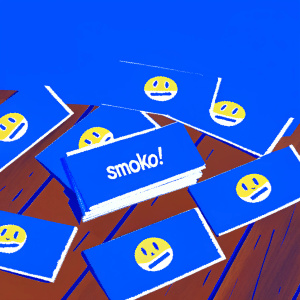 Casual design of Smoko! business cards featuring yellow emoticon and blue background. Scattered on a wooden table
