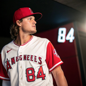 Close-up of Michael Hermosillo in his Los Angeles Angels jersey. Red and white contrast. Number 84 visible on front and back. Angels' logo on chest.