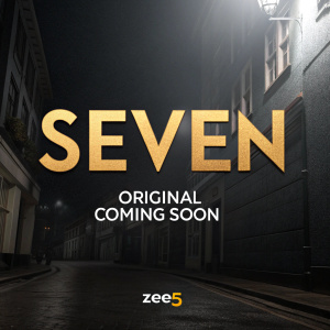 Promotional graphic for Zee5's upcoming series 'SEVEN'. Black background with 'SEVEN' in large gold font. Below reads 'Zee5 Original, Coming Soon' with Zee5 logo at bottom.