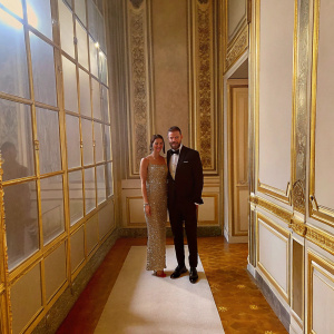 David Beckham in a black suit, Victoria Beckham in a sparkling dress. They are at the Met Gala, posing together on the red carpet.