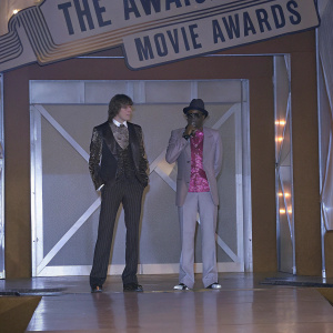 Ashton Kutcher and P. Diddy standing on a stage with MTV Movie Awards banner in the background.