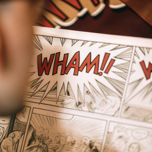 A comic book panel featuring the word 'WHAM!' in bold, dynamic font within a speech bubble, surrounded by intricate line art.