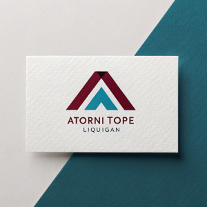 Business card design showcasing 'Atorni Tope Liquigan'. Modern, sleek logo featuring bold maroon 'A' and teal 'T'