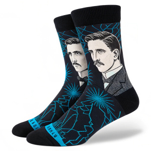 Close-up photo of Nikola Tesla socks. Socks are black with intricate blue Tesla coil patterns.