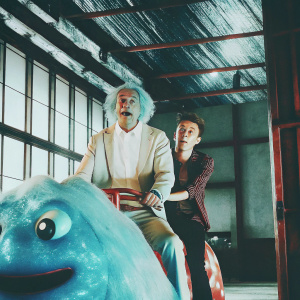 In the animated series Rick and Morty, Rick Sanchez, a human, rides a vibrant, otherworldly creature through a futuristic indoor landscape.