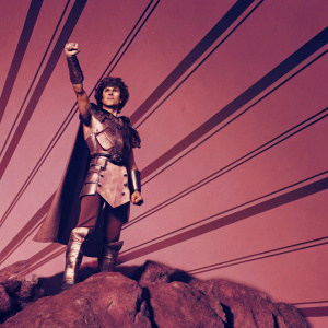Erdrick from Dragon Quest III depicted in vibrant fan art. Standing on a rocky terrain with a heroic pose. Background features an array of pastel hues, creating a surreal atmosphere.