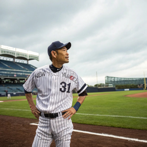 Ichiro Suzuki, wearing a Yankees jersey with the number 31, standing on a baseball field.