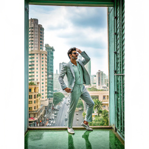 Hrithik Roshan on the cover of GQ magazine, suave pose, stylish outfit, cityscape background