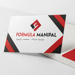 Business card for Formula Manipal. Modern design with bold red and black elements. White background. Logo, company name, email, phone number. Visually striking and professional.