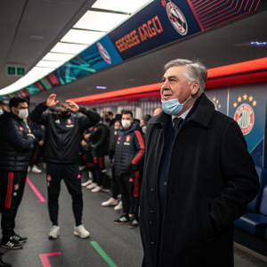 Carlo Ancelotti standing in a bustling locker room. Team members in tracksuits, wearing masks, and cheering in the background. Colorful stadium signage behind.