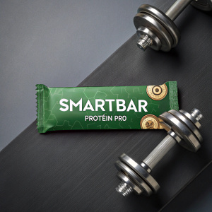 Promotion for SmartBar Protein Pro. A sleek, minimalist design featuring a protein bar, green packaging with graphic elements, and metallic dumbbells. Dark, modern background