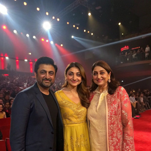 Rajeev Khandewal, Soha Ali Khan, and Mrinalini Sharma at the premiere of a new Bollywood film. Brightly lit stage with spotlights and audience in the background.