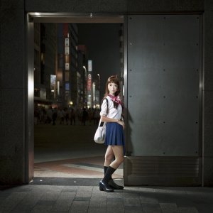 Serena, the iconic heroine of Sailor Moon, in a modern manga style. She stands confidently in her classic fuku, against a backdrop of the bustling streets of Tokyo.