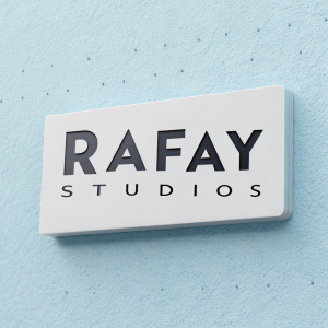 Creative brand identity for Rafay Studios. Modern, sleek logo in bold sans-serif font. Light blue background. Description of services below.