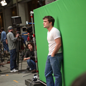 Josh Hutcherson in casual attire. Blue jeans, white t-shirt. Onset of a film production, behind a green screen