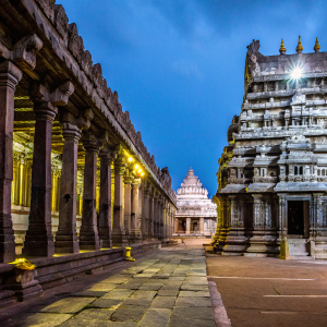 The grand Airavatesvara Temple, located in the serene town of Darasuram, India. This ancient site boasts numerous stone structures adorned with detailed carvings and columns, embodying the essence of traditional Indian architecture.