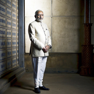 Narendra Modi, Indian politician, in a formal photo shoot. Textured backdrop with political slogans.