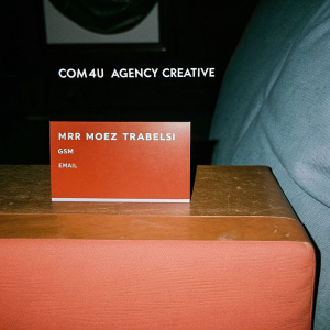 Modern and sleek business card for COM4U Agency Creative. Front features Mr Moez Trabelsi's name in bold letters. Backside includes his contact details: GSM number, email, and physical address.