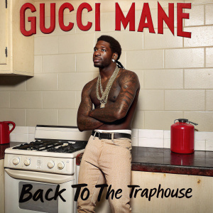 Album cover for Gucci Mane's 'Back to the TrapHouse'. A tattooed male with confident pose in a kitchen setting. Background includes stove and red gas canister. Album title and branding in bold, graffiti-style font.