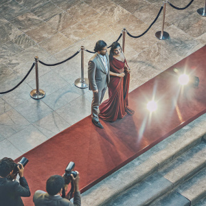 Dr. Modi and actress Katrina Kaif at a Bollywood film premiere. Both are in formal wear, with Katrina in a stunning red velvet saree.