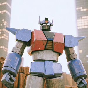 High-tech Mazinger Z robot, with angular design, blue and gray metallic finish, and red accents, in a 3D render.