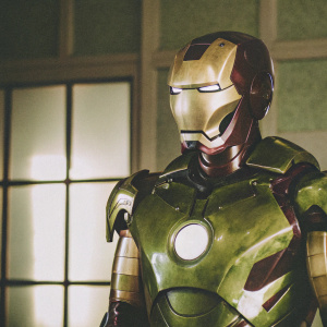 Tony Stark's Iron Man suit, gleaming in metallic gold and black. Detailed close-up of the suit's intricate components.