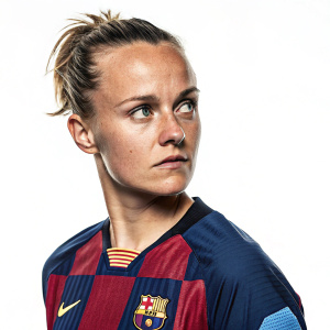 Anna Lisa Timm, soccer star, intense look, cropped hair. Wearing club jersey with logos, white backdrop.