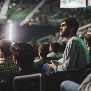 Vikkstar, professional gamer, competing in Call of Duty esports tournament. Crowded arena with cheering fans.