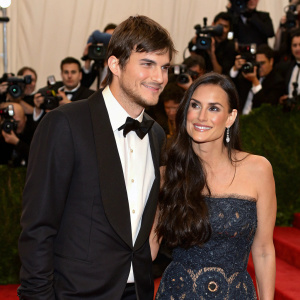 Ashton Kutcher and Demi Moore at a gala event. Red carpet, paparazzi flash photography