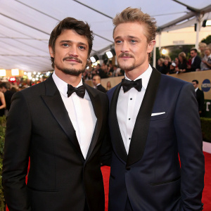 Pedro Pascal and Boyd Holbrook at a glamorous awards show. Red carpet event, evening gowns and suits.
