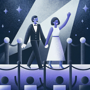 Bob Odenkirk and Naomi Yomtov at an awards show. They are walking on a red carpet. The background features flashing cameras and excited fans.