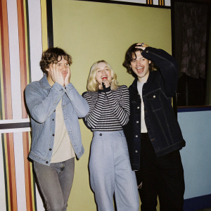 R5 band members, playful smiles, colorful Teen Choice Awards backdrop.