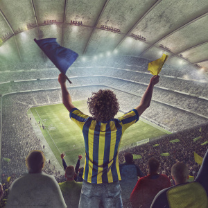 Fanatic Fenerbahçe supporter, curly hair, wearing team's striped jersey, passionate pose in the stands. Soccer stadium, vibrant crowd, live game