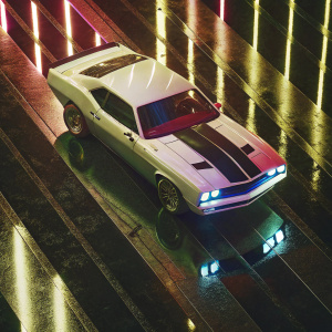 Futuristic Dodge Hellcat SRT concept car, white with blue accents, on a glossy black surface. High contrast lighting highlights car's sleek design, reflecting dramatic shadows.