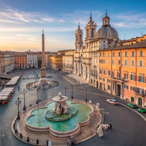 Stunning aerial view of Piazza Navona, Rome, Italy. Historical architecture, vibrant colors, central fountain, ornate details, wide-open space, clear blue sky.