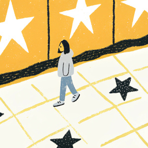 Camila Cabello walking on Hollywood Walk of Fame. Wearing a casual hoodie and jeans. Grey pavement with stars