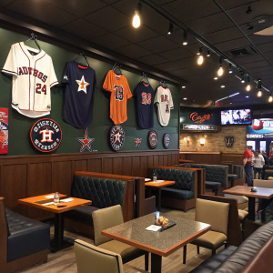 Inside a baseball-themed sports bar. Houston Astros decor, booths and tables.