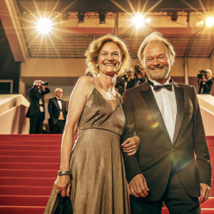 Cheerful Martina Gedeck and Klaus Maria Brandauer posing together at Cannes Film Festival.